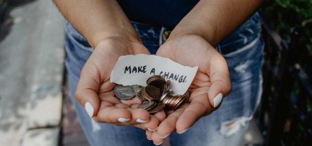 Woman holding coins in hands.